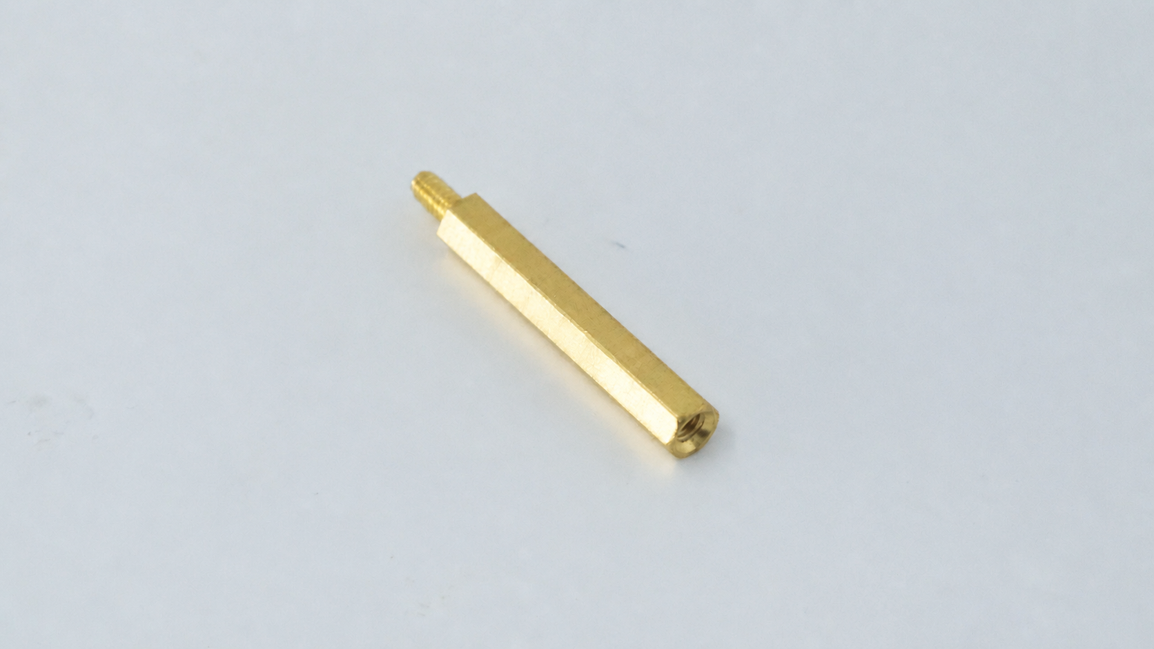 M2.5 Brass Hex Standoff, Male-Female, 6mm — representative natural brass male-female standoff on original background
